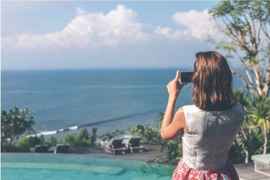 womna taking a picture of a beautiful view