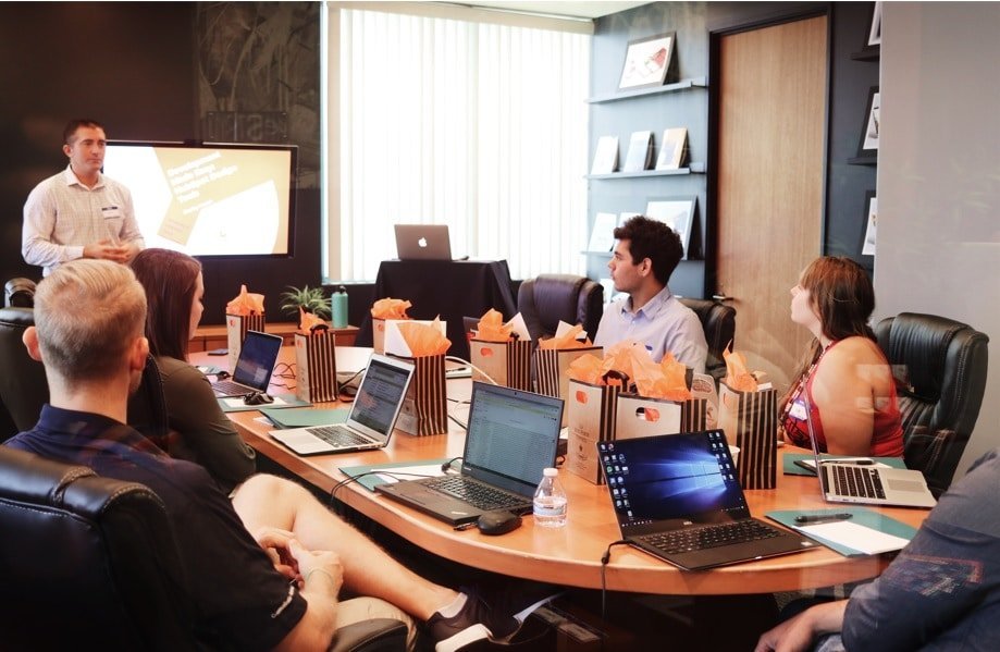 a group of peole at work watching a presentation